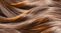 Beautiful healthy shiny hair texture with highlighted golden str