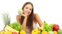 beautiful young woman with fruits and vegetables, isolated on white