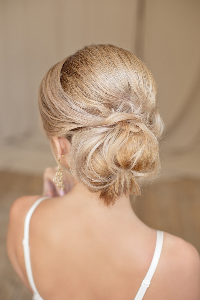 Rear view of female hairstyle middle bun with blond hair