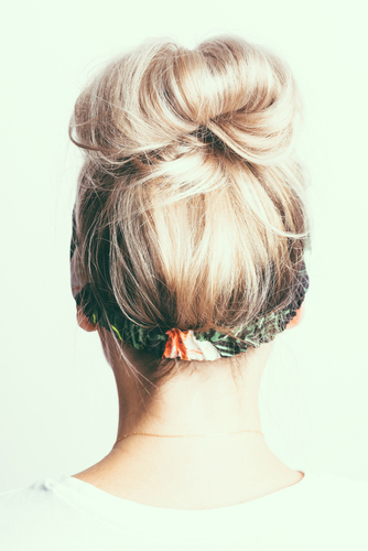 Blonde,Girl,With,A,Bun,Of,Hair,On,Her,Head,